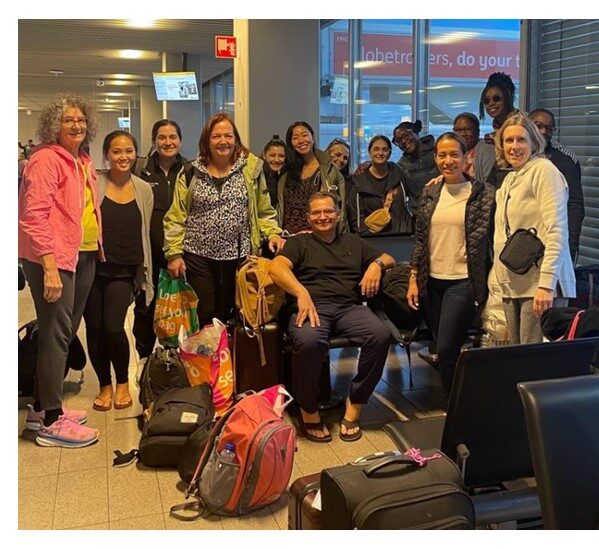 florence rolston and medical outreach gathering in a lobby for a picture