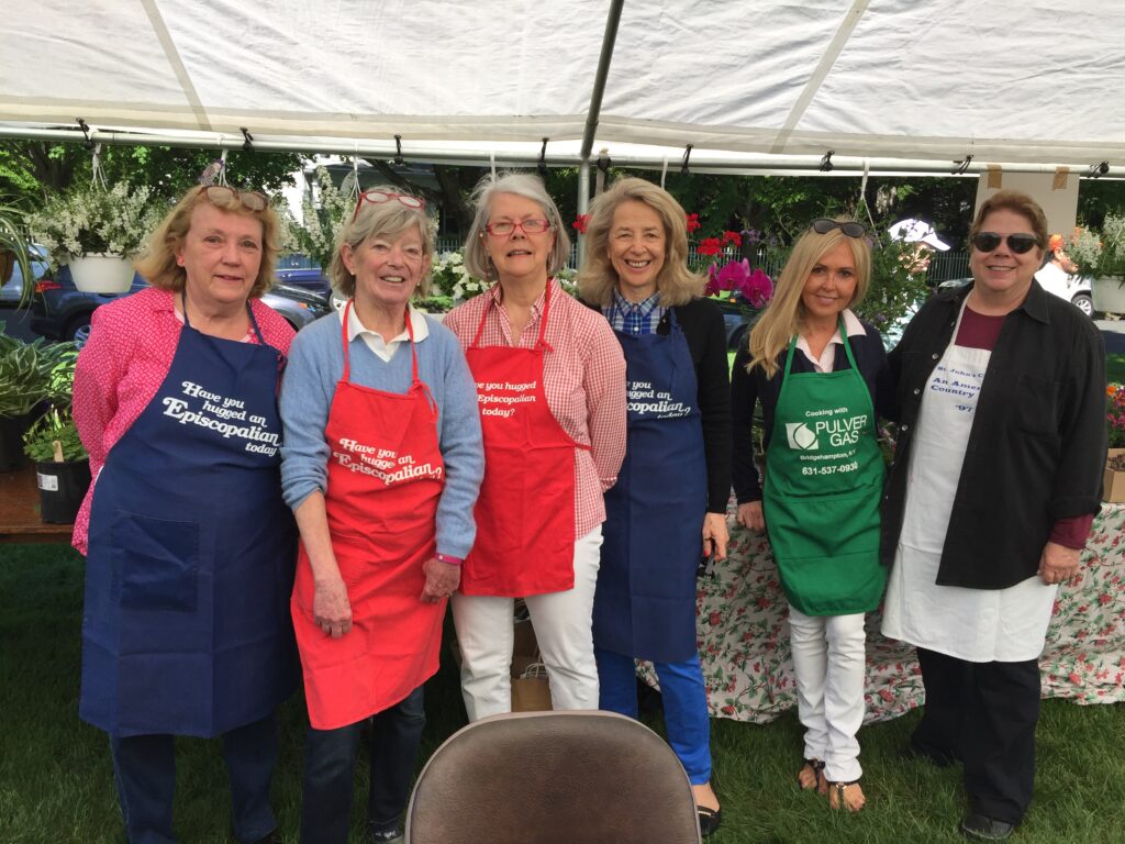 Women wearing aprons at the St. John's Annual Summer Bazaar